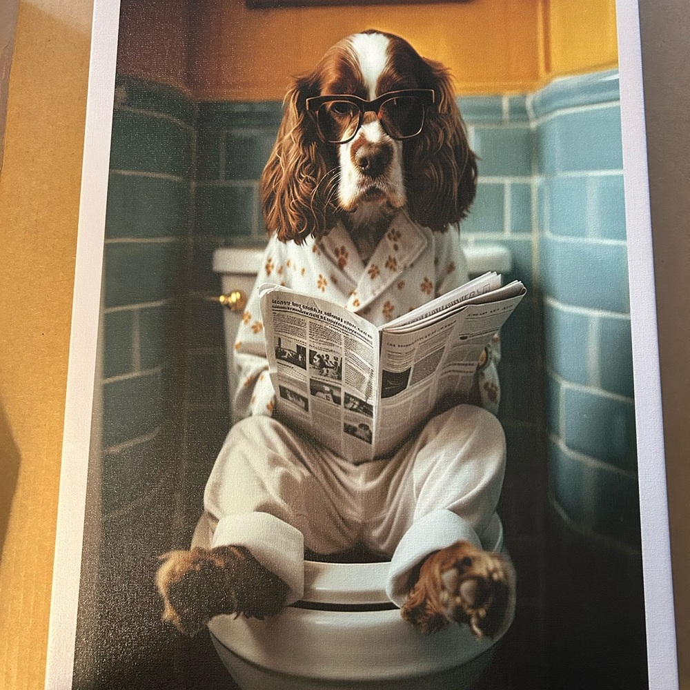Spaniel Dog on the toilet reading newspaper